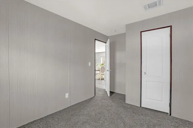 a view of an empty room and closet area