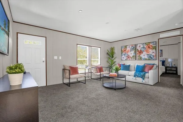 a living room with furniture and a large window