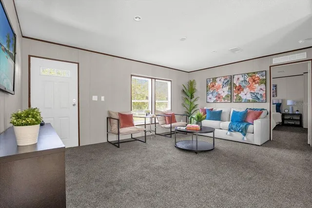 a living room with furniture and a large window