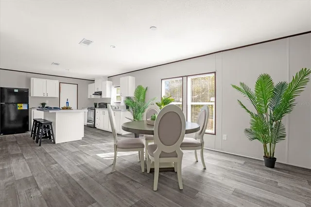 a living room with furniture and a kitchen area
