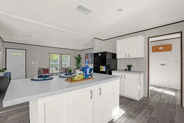 a open kitchen with sink cabinets and wooden floor