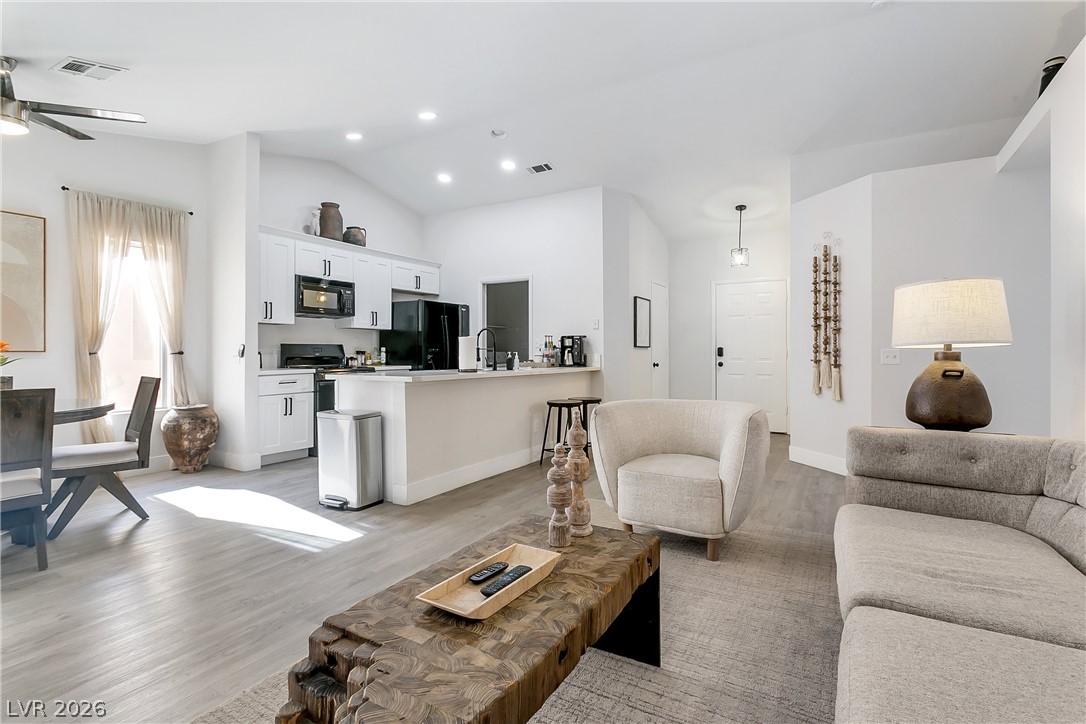 101 Beaver Ridge Avenue North Las Vegas, NV 89031 - Photo 6 of 42 An open concept living area features soaring vaulted ceilings, a well-appointed kitchen, and abundant natural light.