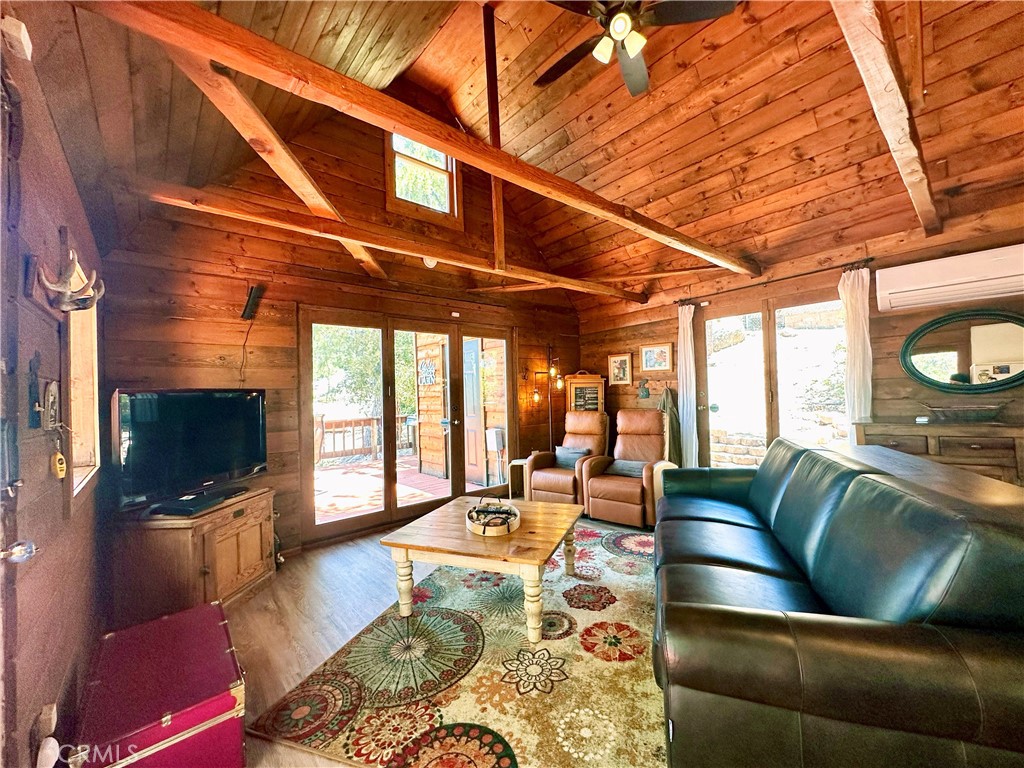 24387 Rocky Point Road Idyllwild, CA 92549 - Photo 13 of 29 a living room with furniture wooden floor and a flat screen tv