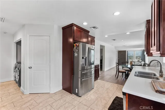 a kitchen with stainless steel appliances granite countertop a refrigerator and a sink