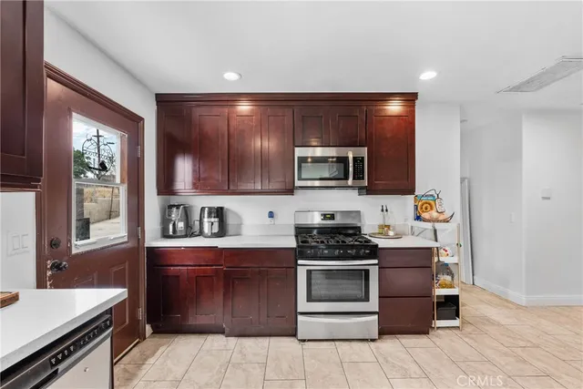 a kitchen with stainless steel appliances a stove sink and microwave
