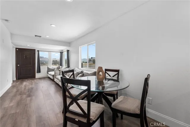 a view of a dining room with furniture and a floor to ceiling window