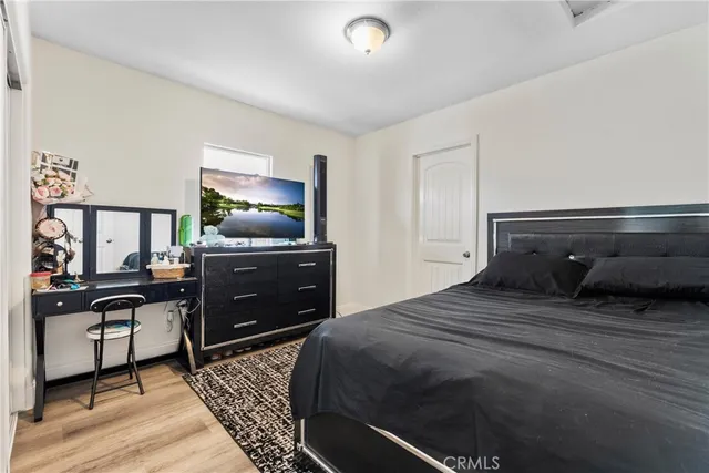 a bedroom with a bed and a flat screen tv