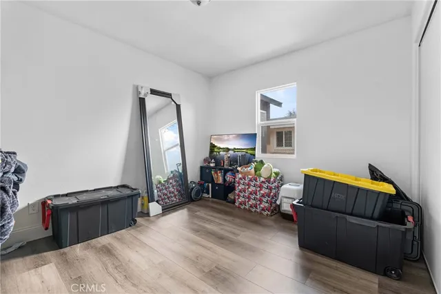 a bedroom with furniture and a wooden floor