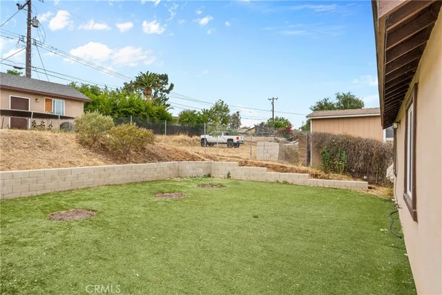 a backyard of a house with table and chairs