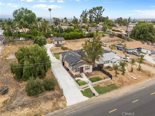 an aerial view of a house with yard swimming pool and ocean view