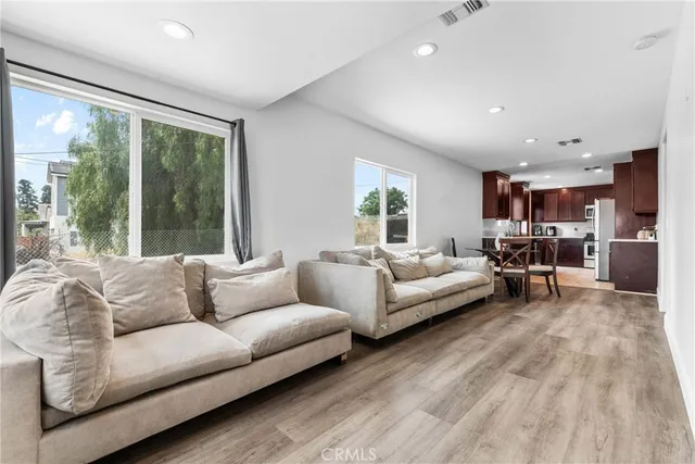 a living room with furniture and large windows