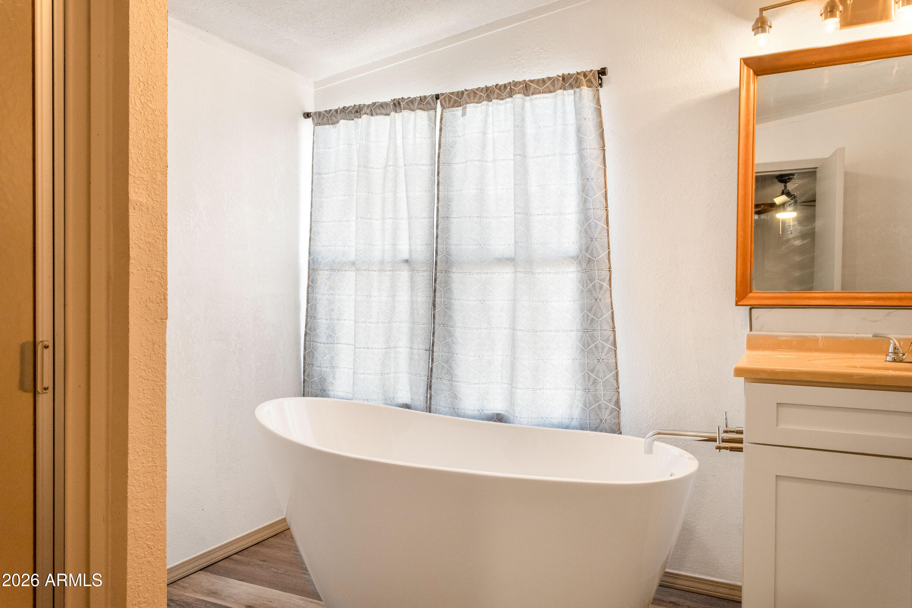 10405 North Mormon Road Elfrida, AZ 85610 - Photo 20 of 43 a bath tub sitting in a bathroom next to a window