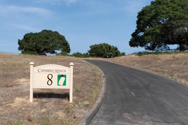 a view of a street with sign board