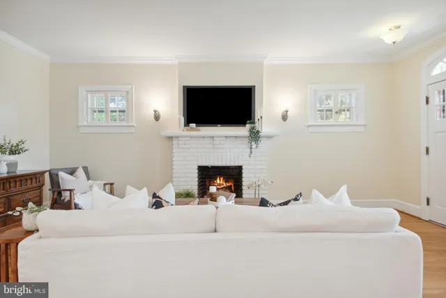 a kitchen with stainless steel appliances granite countertop a stove a refrigerator a microwave cabinets and chairs