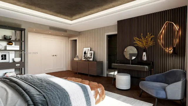 a large bedroom with a bed and wooden floor