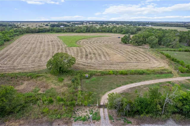 an aerial view of a house with a yard and outdoor seating