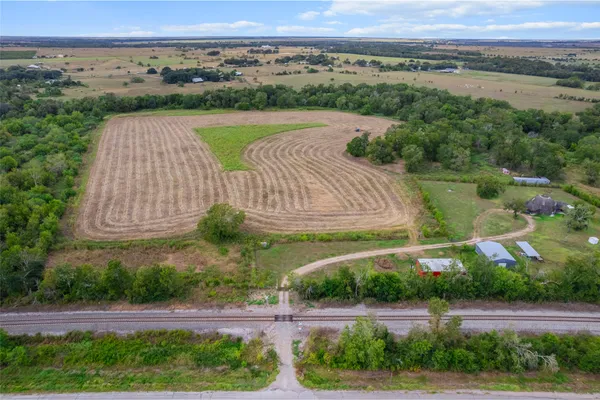 an aerial view of a house with a yard and lake view