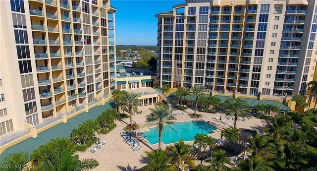 a view of a backyard with plants and large trees