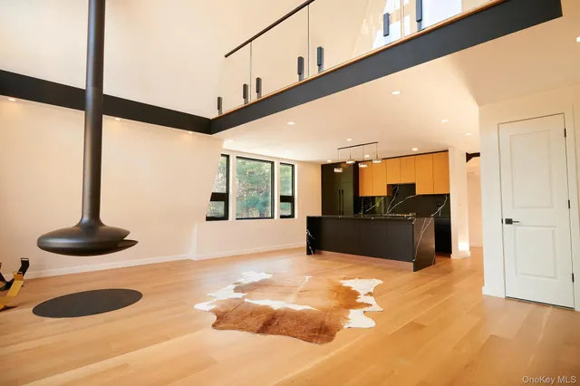 a view of a living room with furniture and floor to ceiling window