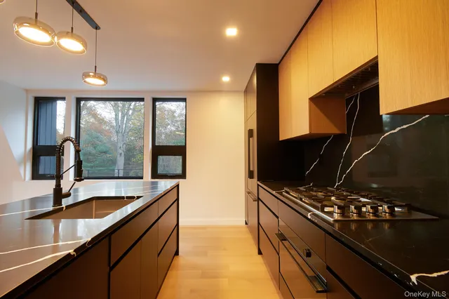 a kitchen with sink a counter and cabinets