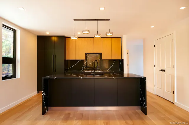 a living room with table chairs and wooden floor