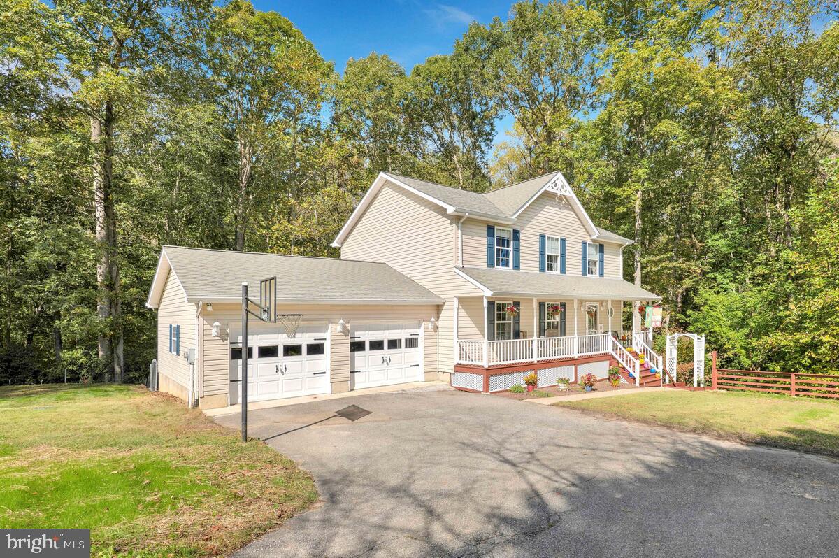 165 Ball Road St. Leonard, MD 20685 - Photo 2 of 55 a view of a white house with a big yard and large trees