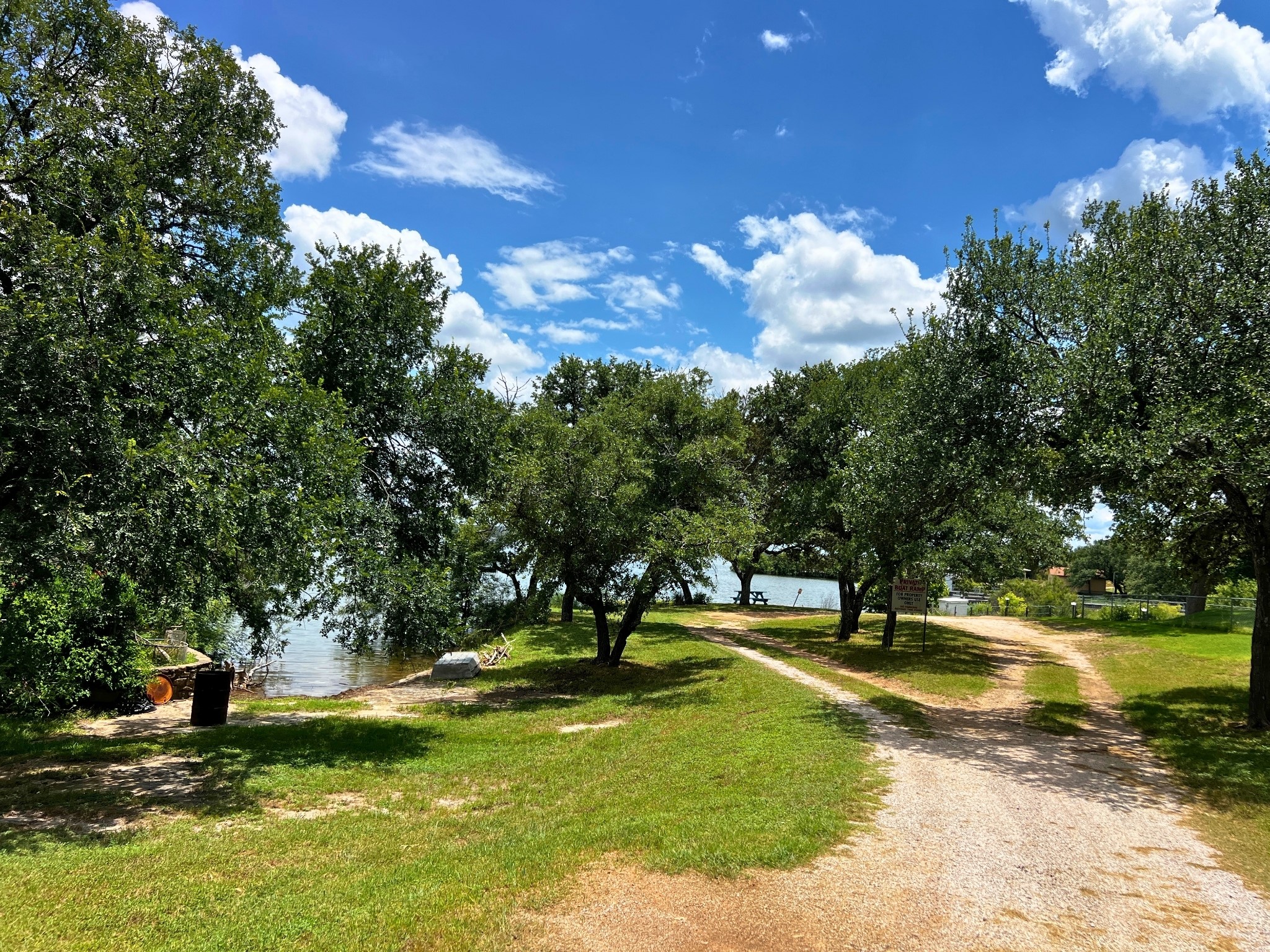 706 Cr138a Road Burnet, TX 78611 - Photo 16 of 18 A tranquil lakefront property awaits, offering a private escape with mature trees and direct water access.