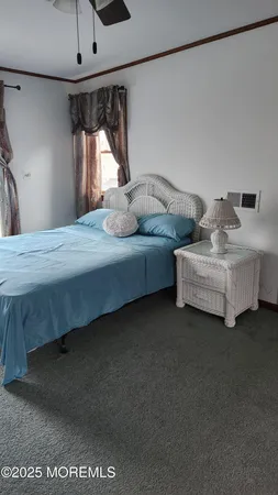 a bedroom with bed and window