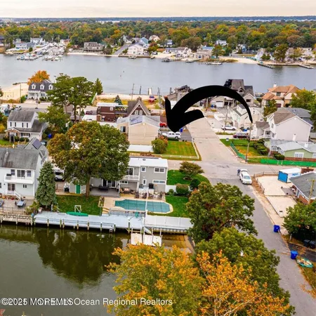 an aerial view of a house with lake view
