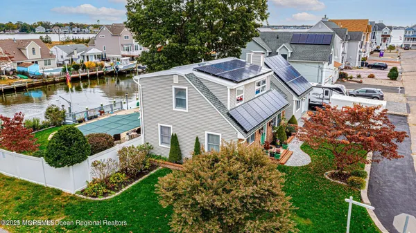 an aerial view of a house with a lake view
