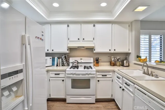 a kitchen with stainless steel appliances granite countertop a sink and cabinets