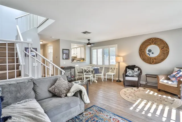 a dining room with wooden floor a chandelier a wooden table and chairs