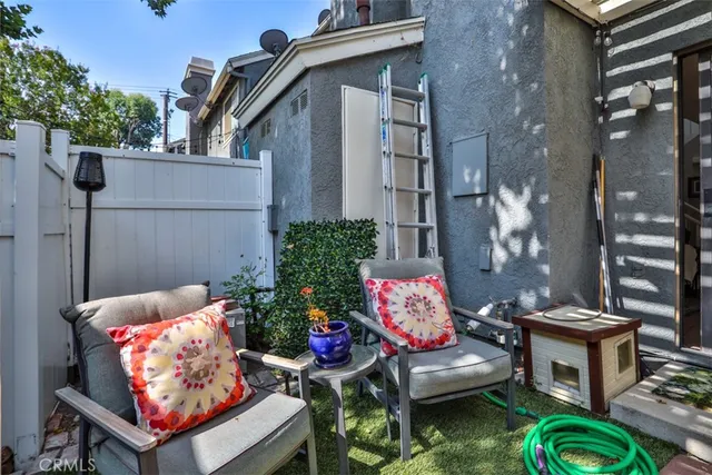 a view of a chairs and table in backyard of the house