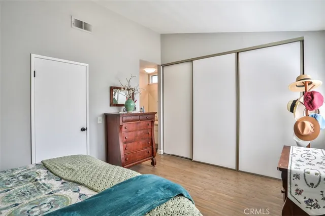 a bedroom with a bed and painting on the wall