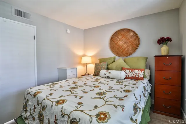 a bedroom with a bed and lamp