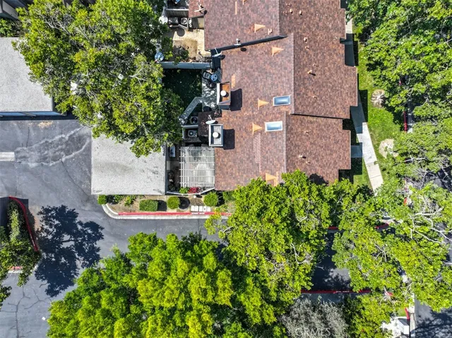 an aerial view of a house with a garden and statue