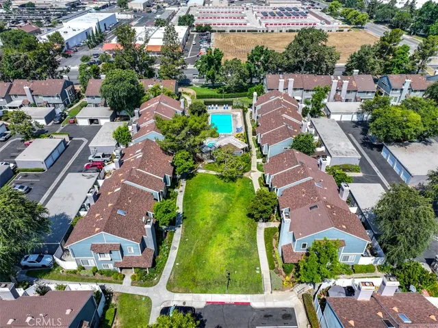 an aerial view of residential houses with outdoor space