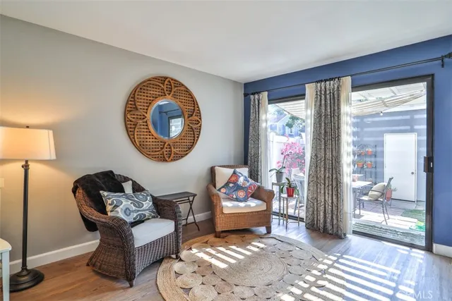 a view of a livingroom with furniture a fireplace and wooden floor