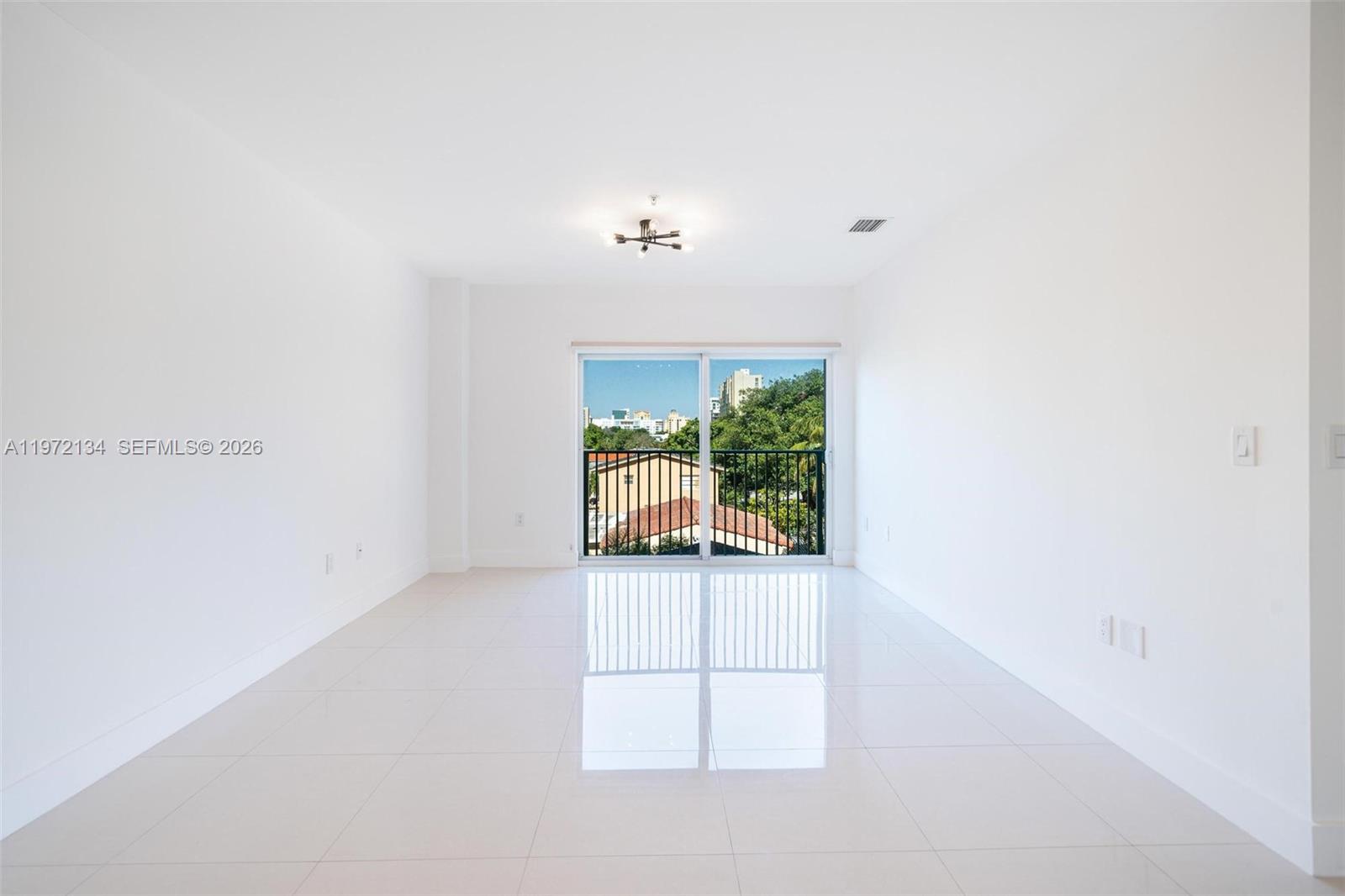 2280 Southwest 32nd Avenue, Unit 201 Miami, FL 33145 - Photo 11 of 23 a view of a livingroom with a furniture and floor to ceiling window