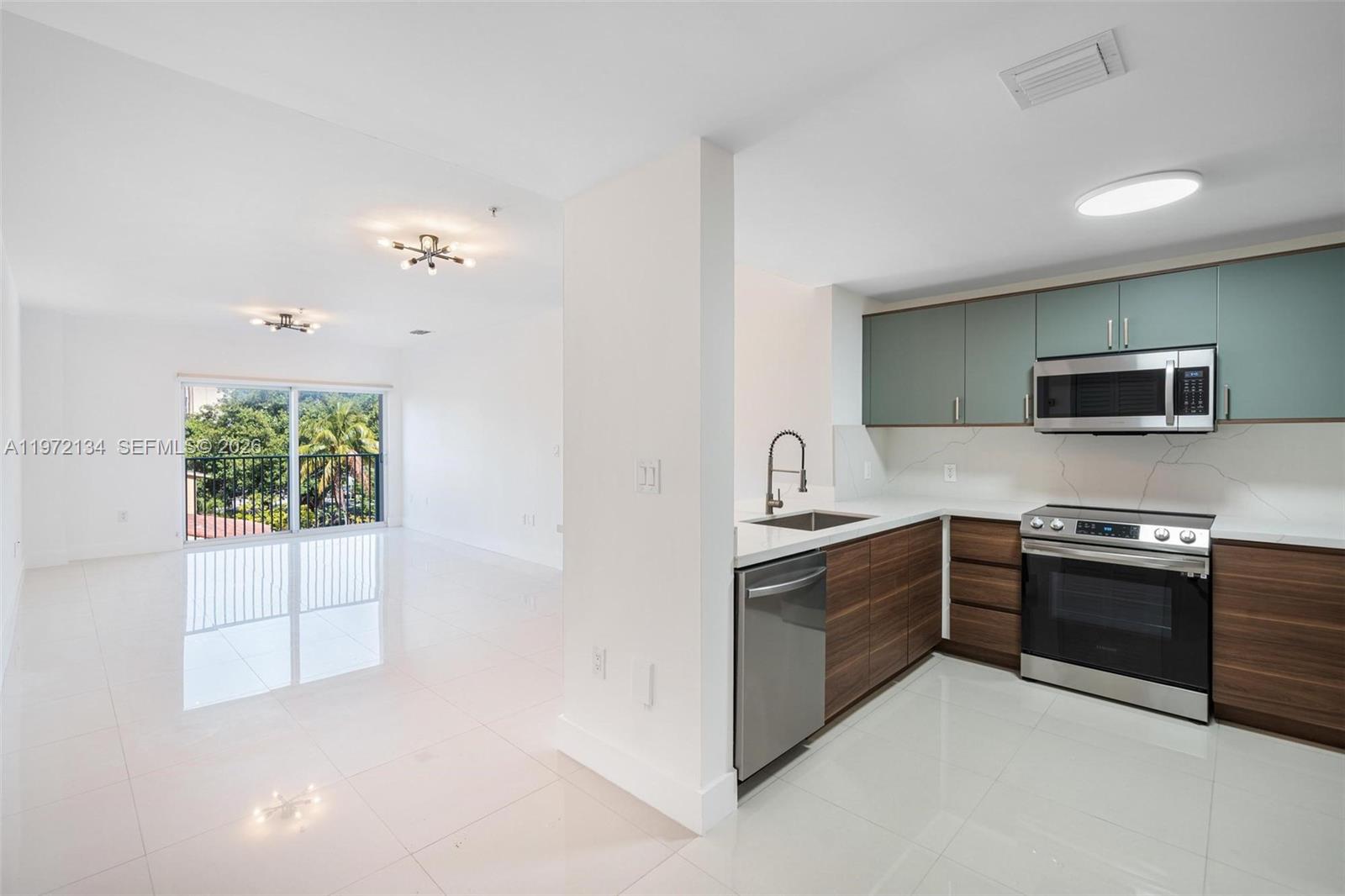 2280 Southwest 32nd Avenue, Unit 201 Miami, FL 33145 - Photo 2 of 23 a kitchen with stainless steel appliances granite countertop a stove and a sink