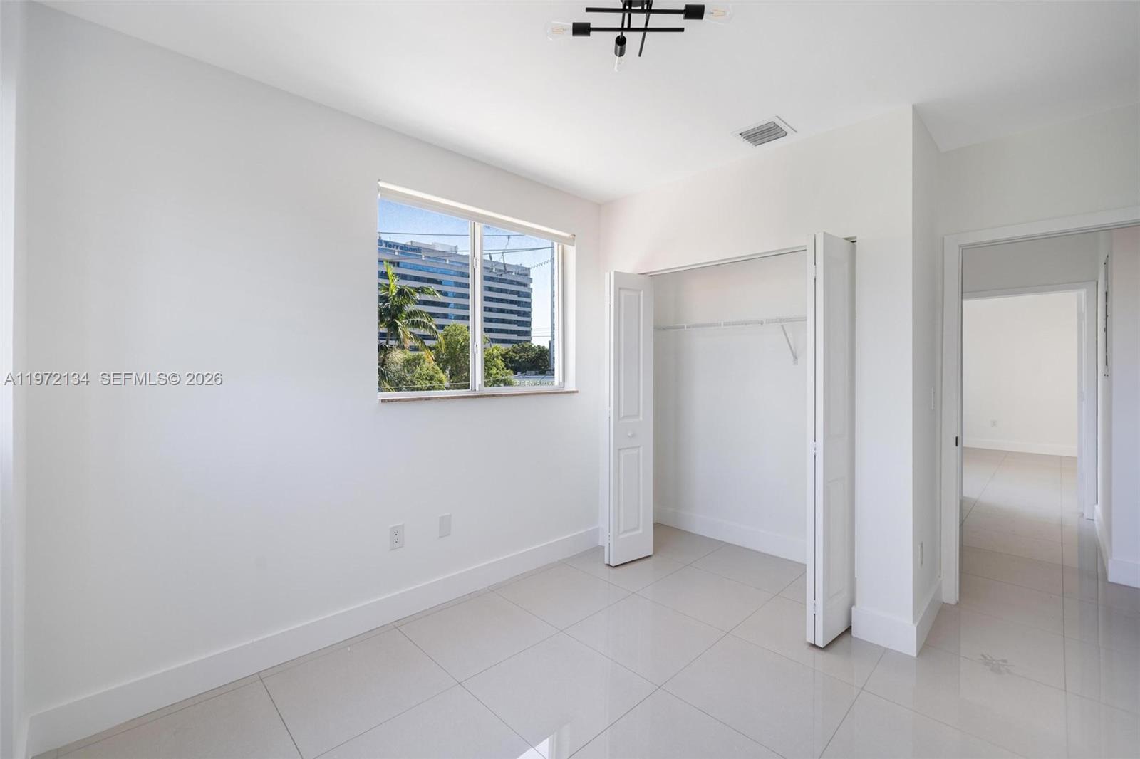2280 Southwest 32nd Avenue, Unit 201 Miami, FL 33145 - Photo 21 of 23 a view of an empty room with a window