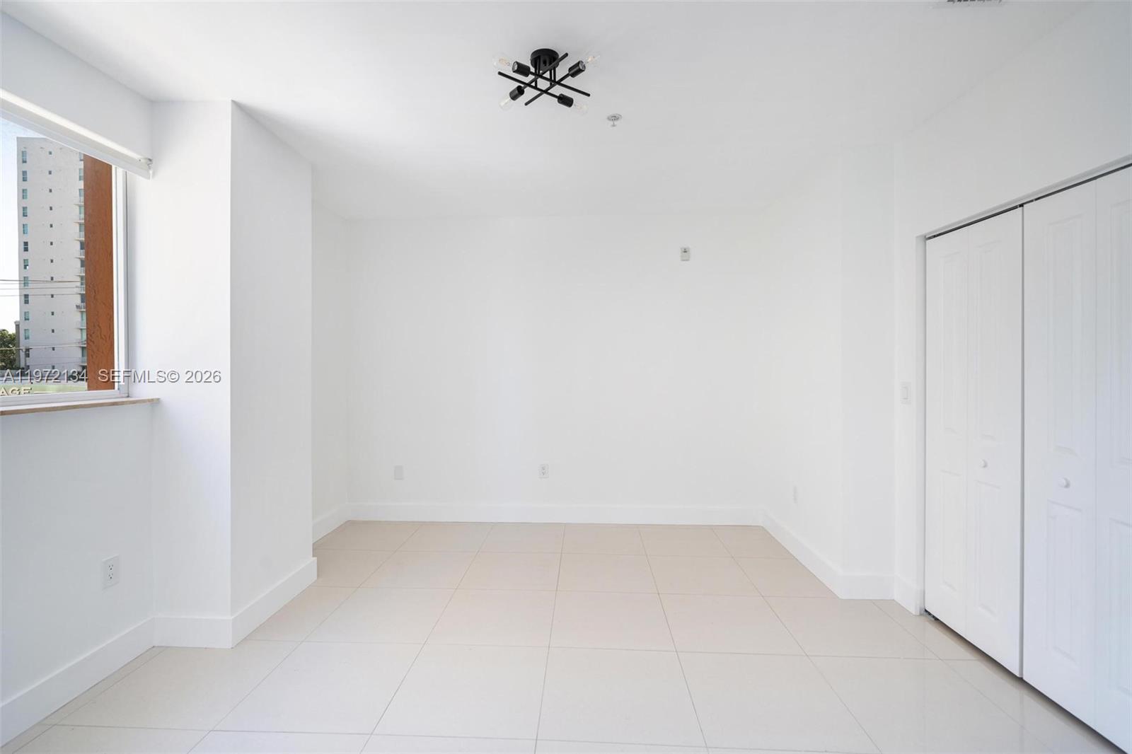 2280 Southwest 32nd Avenue, Unit 201 Miami, FL 33145 - Photo 22 of 23 an empty room with a window