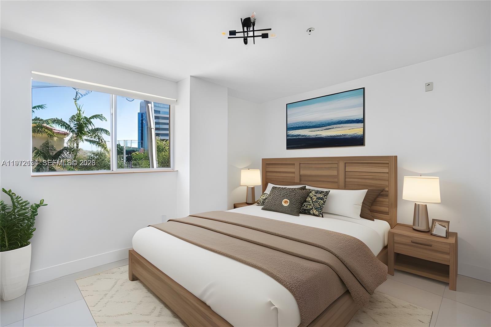 2280 Southwest 32nd Avenue, Unit 201 Miami, FL 33145 - Photo 5 of 23 a bedroom with a bed and a painting on the wall