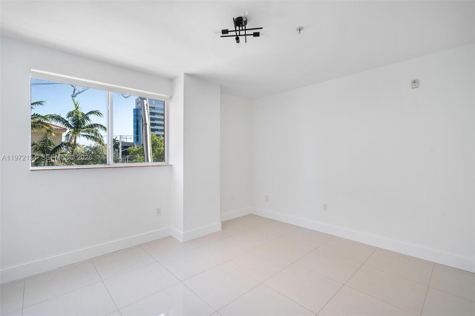 2280 Southwest 32nd Avenue, Unit 201 Miami, FL 33145 - Photo 6 of 23 an empty room with windows