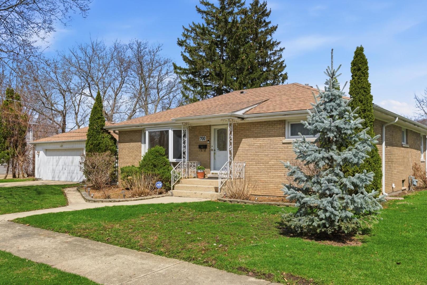 a view of a house with a yard and sitting area