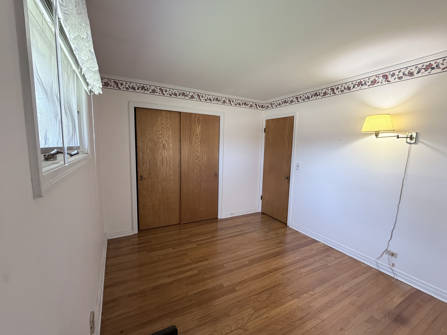 700 Ford Avenue Elgin, IL 60120 - Photo 12 of 20 a view of an empty room with wooden floor and a window