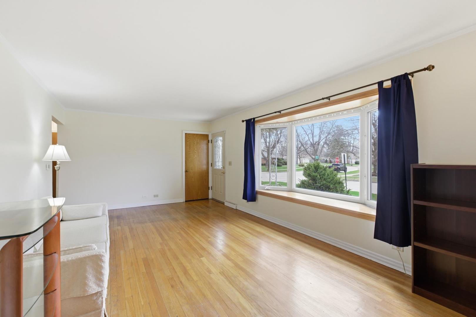700 Ford Avenue Elgin, IL 60120 - Photo 3 of 20 a view of empty room with wooden floor and fan