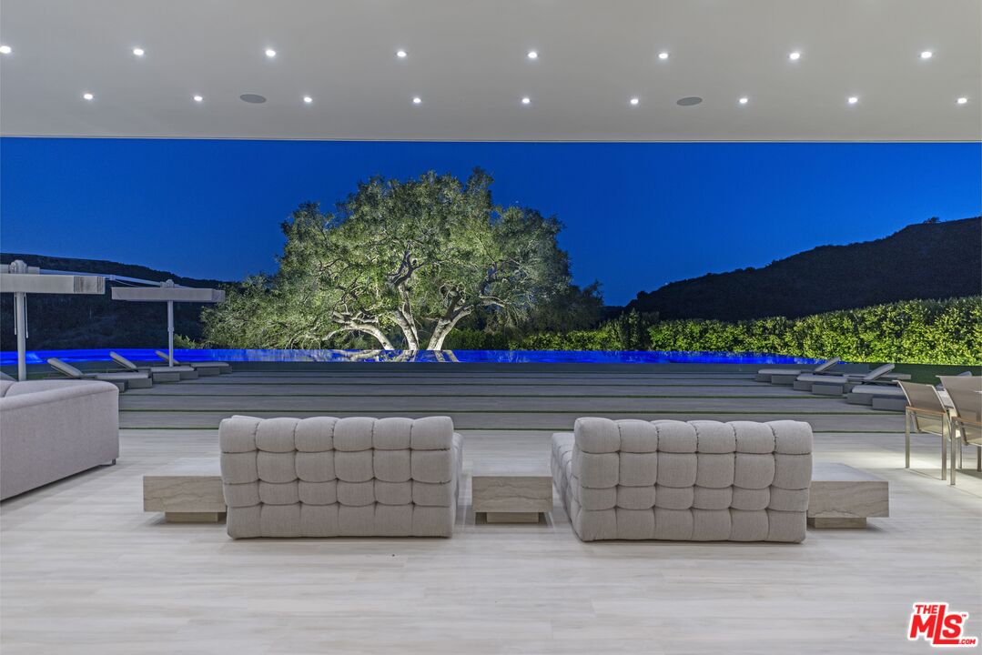 2571 Wallingford Drive Beverly Hills, CA 90210 - Photo 19 of 23 a living room with couches and a table with potted plants