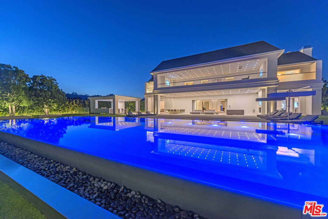 2571 Wallingford Drive Beverly Hills, CA 90210 - Photo 2 of 23 a view of swimming pool with red chairs