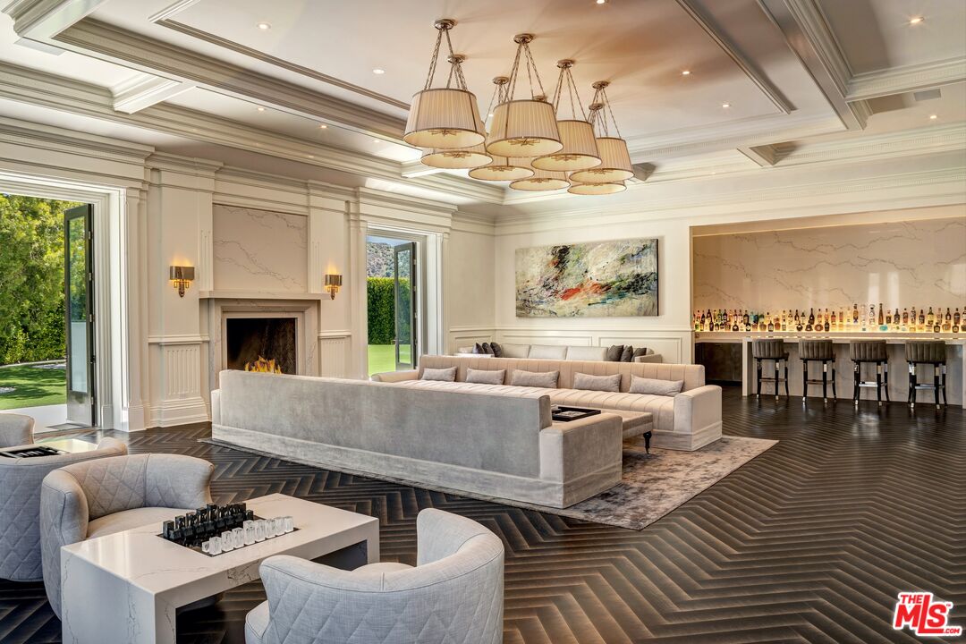 2571 Wallingford Drive Beverly Hills, CA 90210 - Photo 5 of 23 a living room with furniture and a chandelier